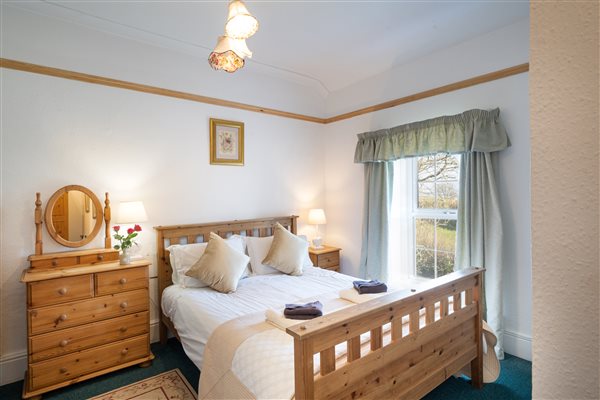 En-suite master bedroom in The Farmhouse with hot tub